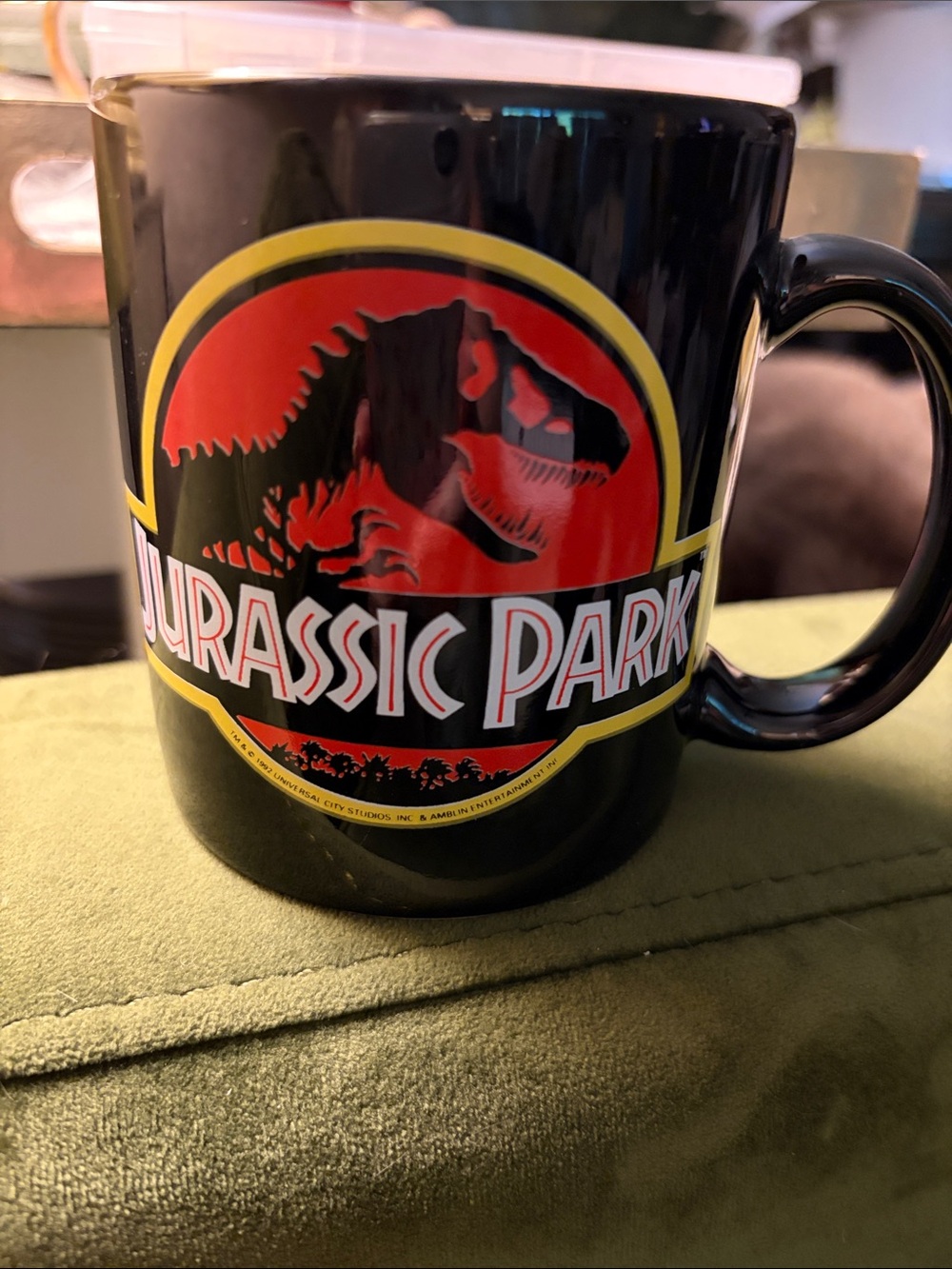1992 Dankin Official Jurassic park black coffee mug featuring classic Trex logo
